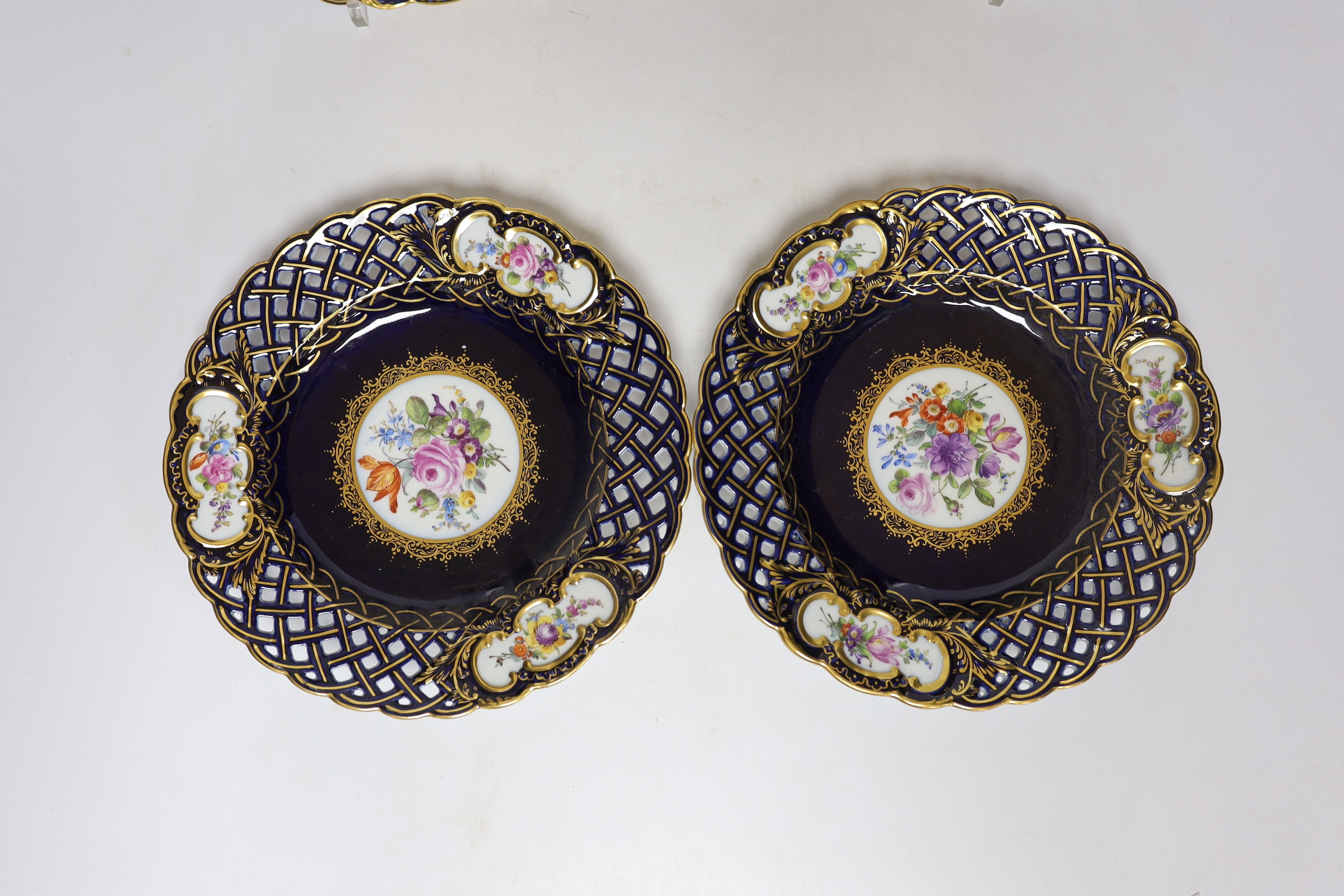 A set of four Dresden blue porcelain cabinet plates decorated with flowers, 21cm